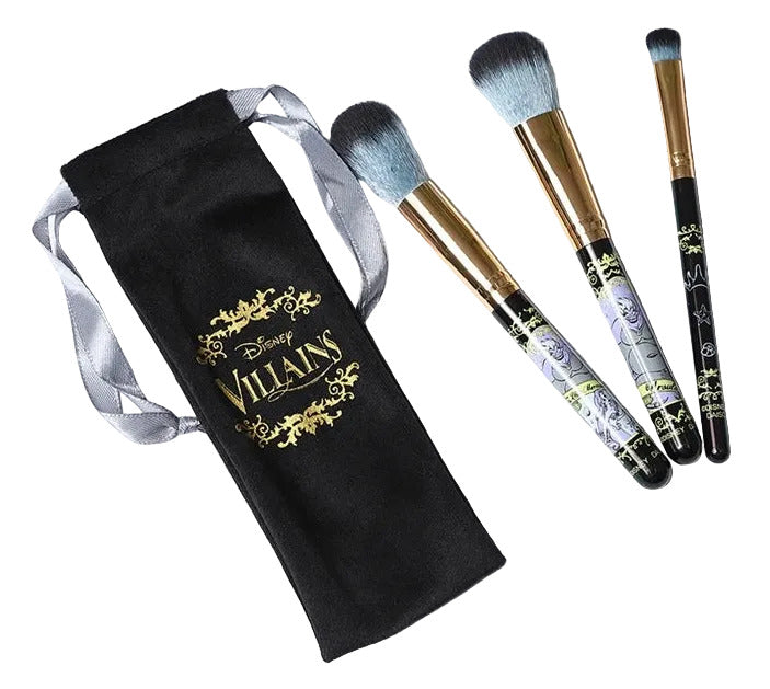 Set of makeup brushes with a black Villains-themed pouch on a white surface.