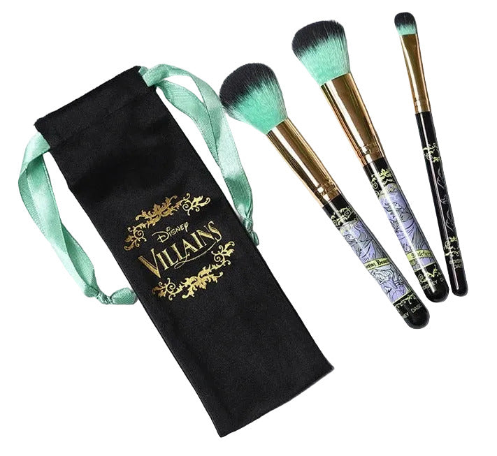 Set of makeup brushes with decorative handles on a black pouch labeled 'Disney Villains' on a white surface.