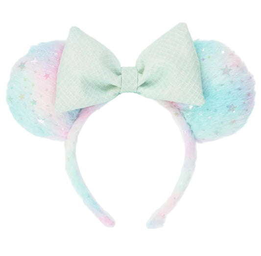 Pastel-colored bunny ears with a bow on a white background